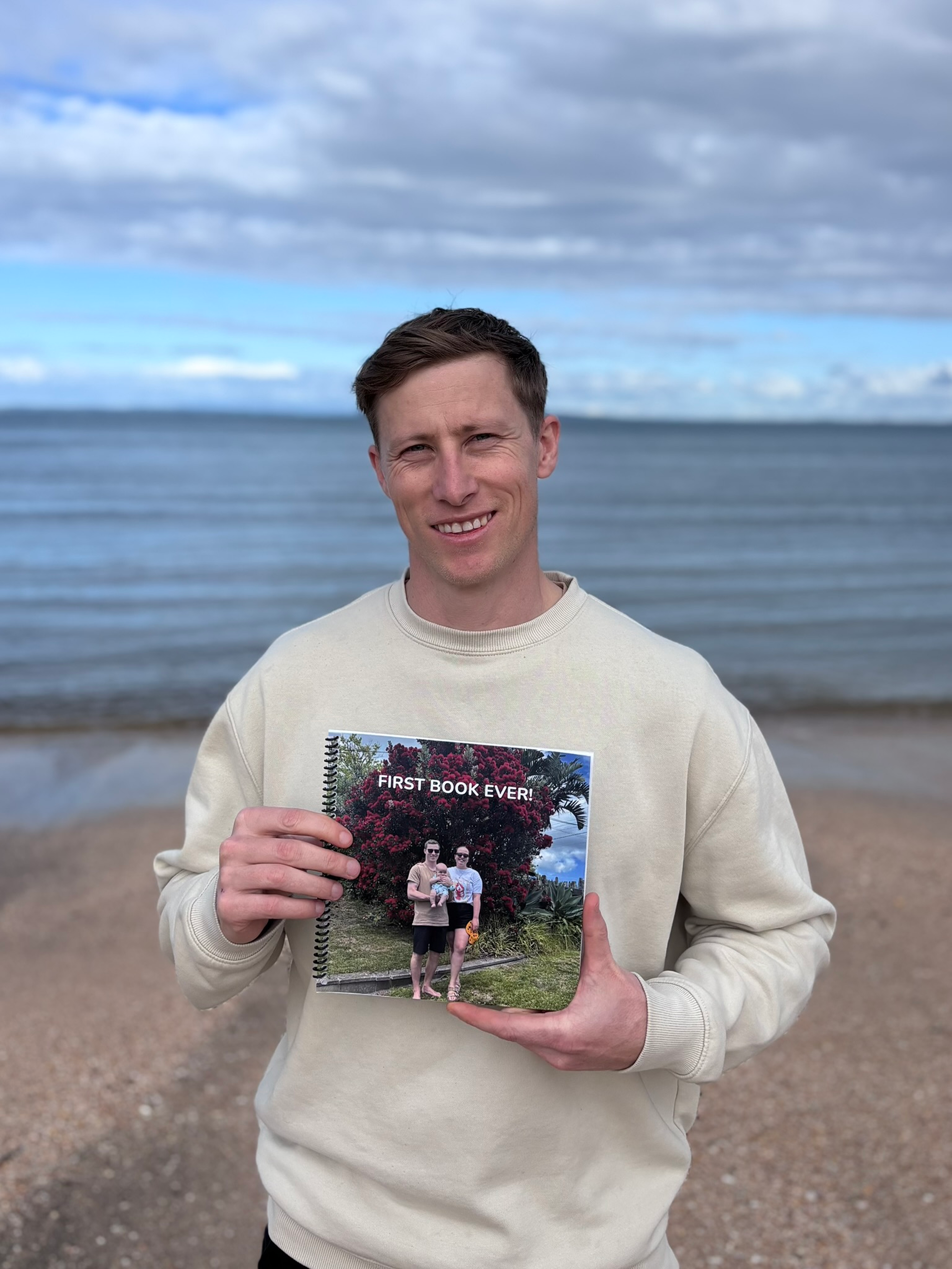 Chris, founder of Bound by Moments, holding the first book ever printed